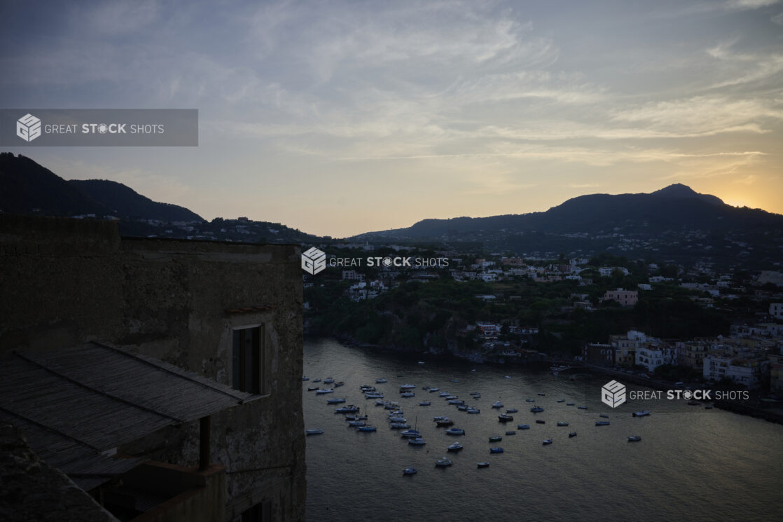 Overhead view of an Italian coastline and marina at sunset on the Mediterranean sea