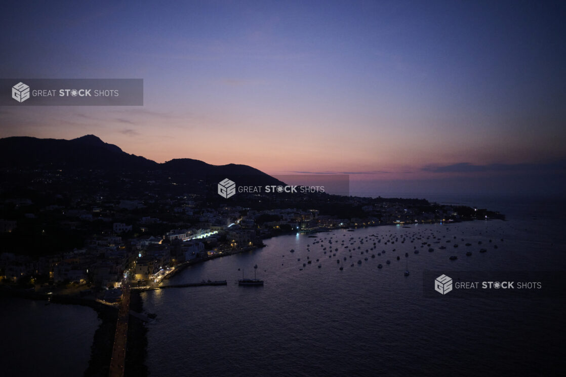 Wide Shot Overlooking Amalfi Coast, Harbour and Bay with boats, and lights at night, just after sunset