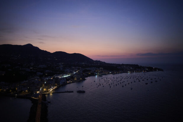 Wide Shot Overlooking Amalfi Coast, Harbour and Bay with boats, and lights at night, just after sunset