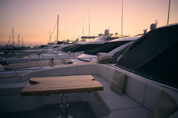 Medium Shot of Multiple Luxury Yachts in a Harbour at Sunset