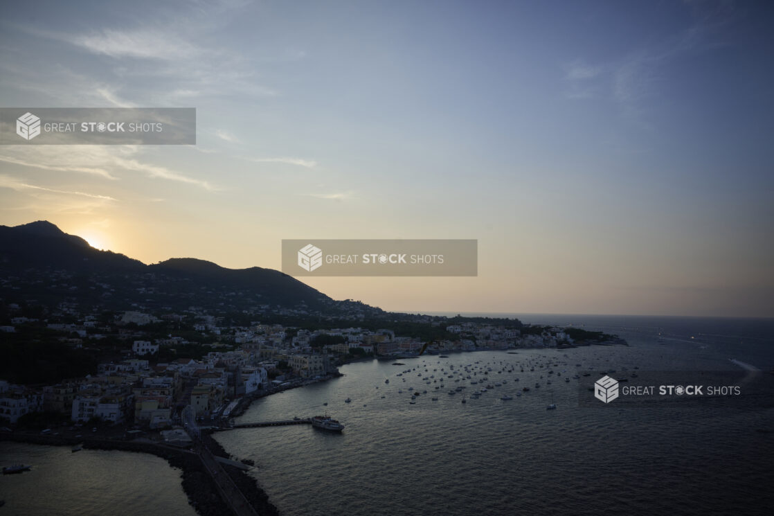 Overhead view of an Italian coastline and marina at sunset on the Mediterranean sea