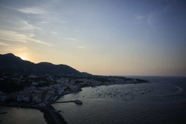 Overhead view of an Italian coastline and marina at sunset on the Mediterranean sea