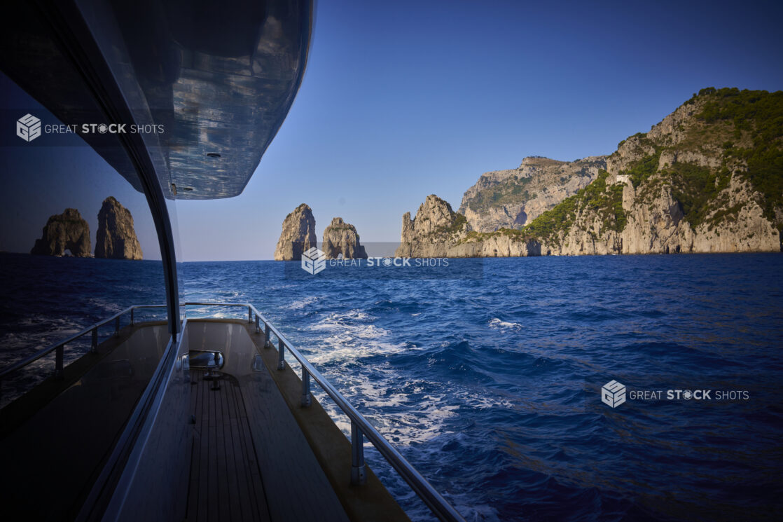 View of the sea, islands and hills from the side of a yacht