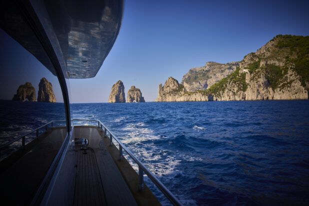 View of the sea, islands and hills from the side of a yacht