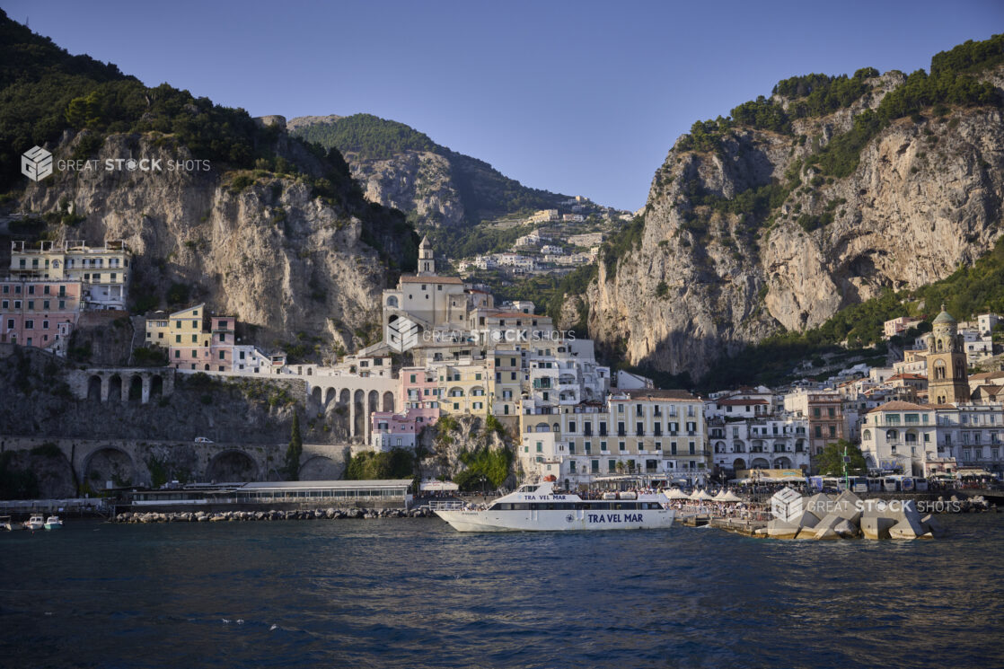 View of the Amalfi coast, Italy from the water, looking at buildings and the coastline and a yacht