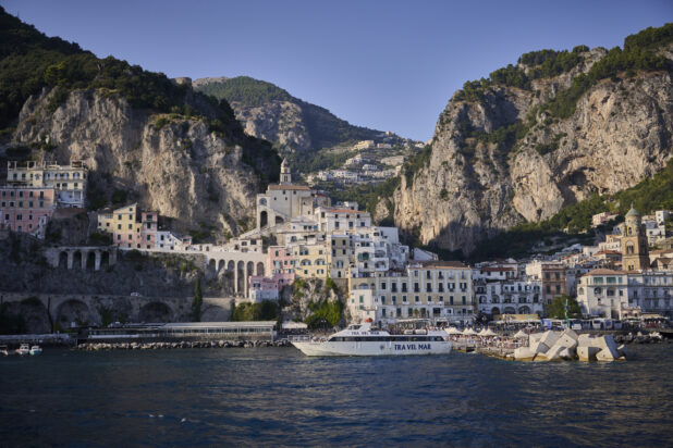 View of the Amalfi coast, Italy from the water, looking at buildings and the coastline and a yacht