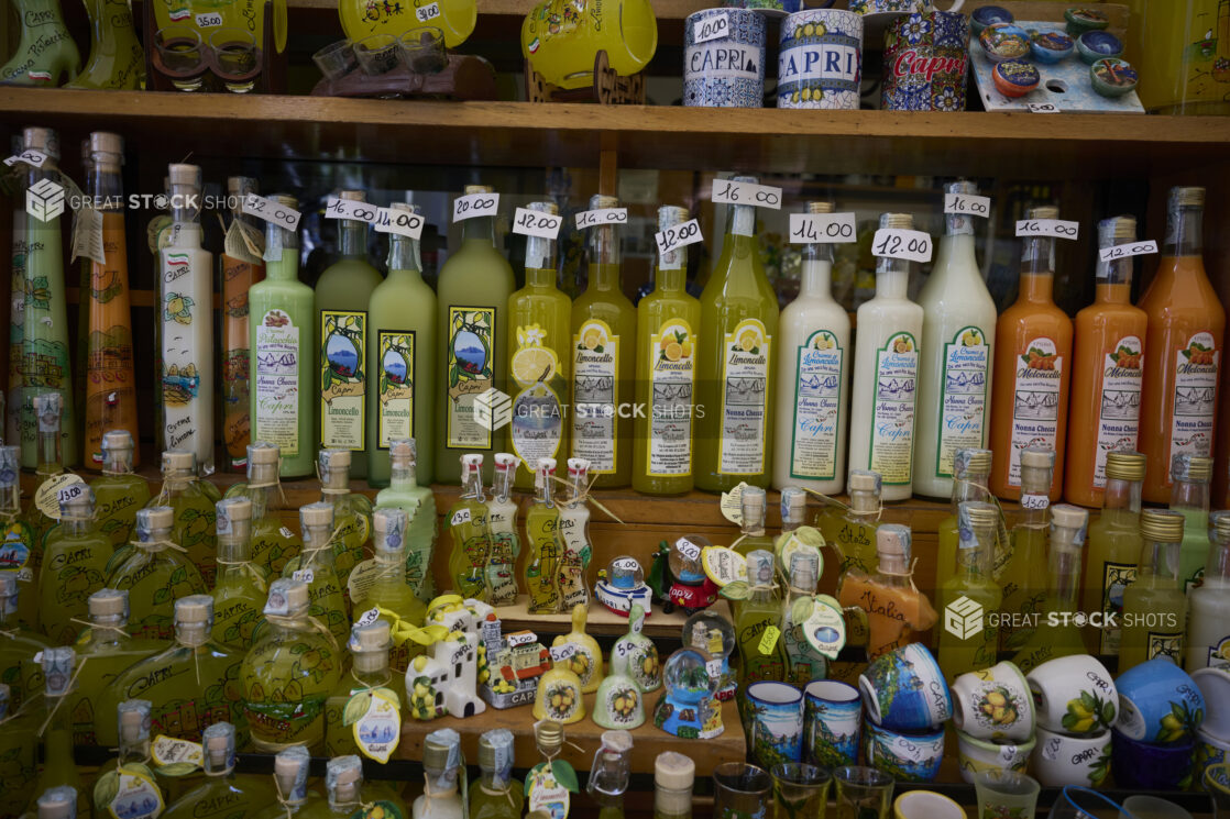 Shelves with colourful souvenirs and bottles of liqueur in a souvenir shop in Capri, Italy