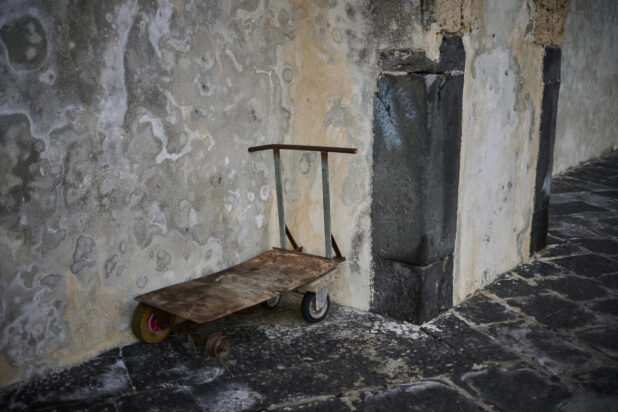 A pushcart in a corner on a side street in Italy