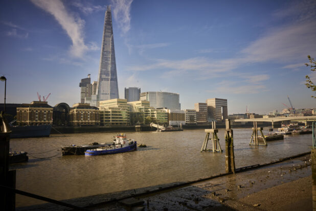 View of the Thames river in London, England with boats and buildings