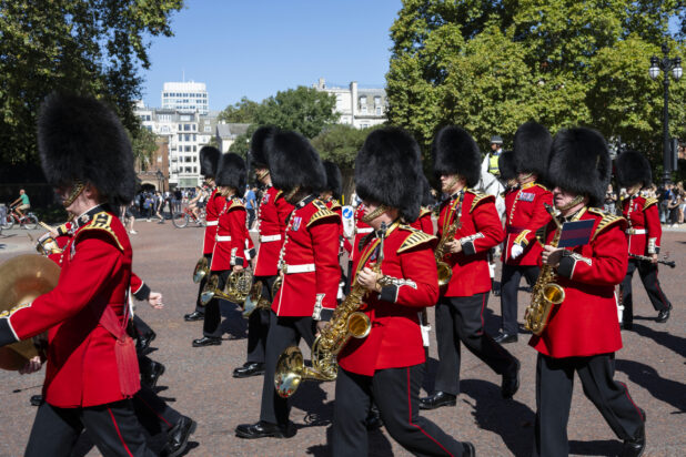 Queens/Kings guard marching band walking down the street, London, England