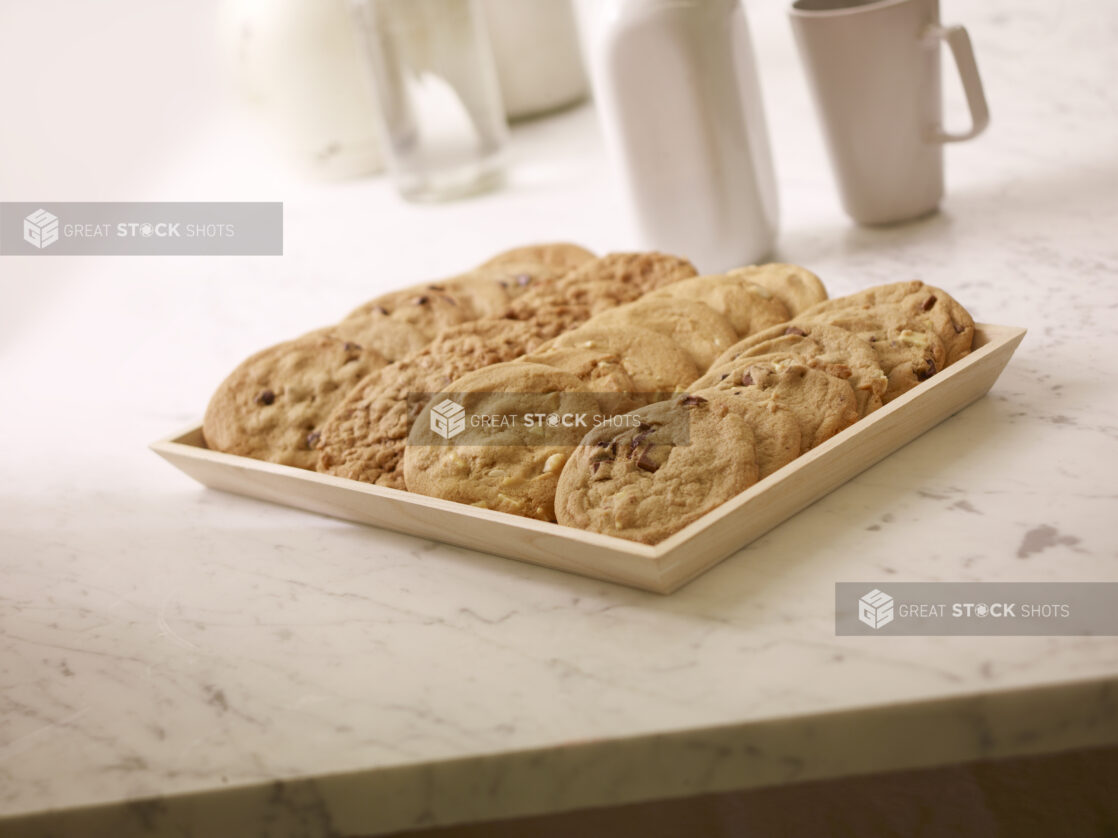 Assorted Cookies on a Square Wood Serving Tray for Catering, on a Marble Counter Top in a Kitchen Setting