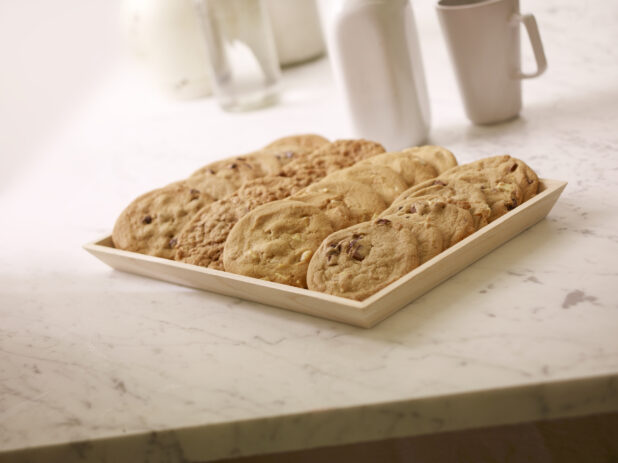 Assorted Cookies on a Square Wood Serving Tray for Catering, on a Marble Counter Top in a Kitchen Setting