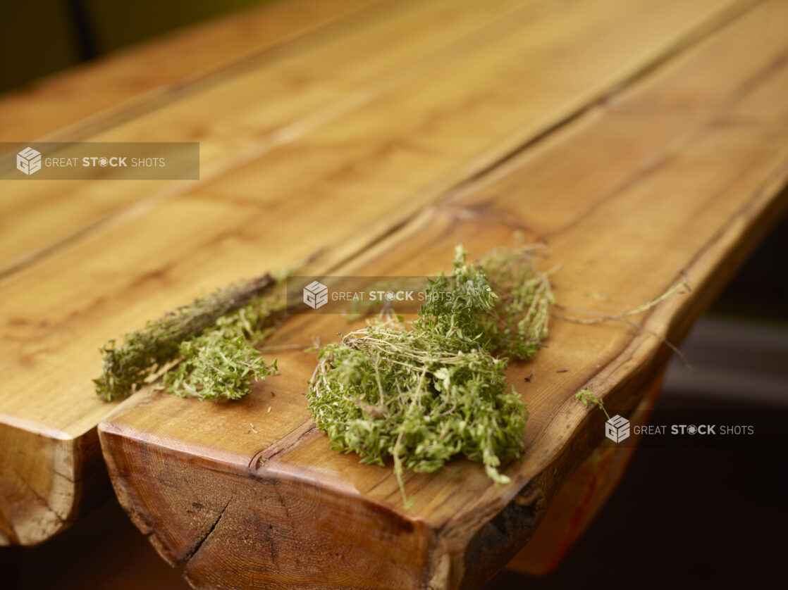 Fresh Bundles of Thyme Sprigs on Wooden Table with Bokeh Effect