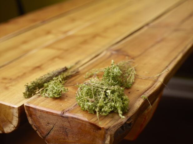 Fresh Bundles of Thyme Sprigs on Wooden Table with Bokeh Effect