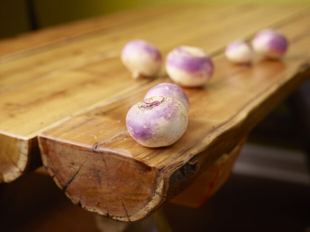 Whole Raw Turnips on a Wooden Table with Bokeh Effect