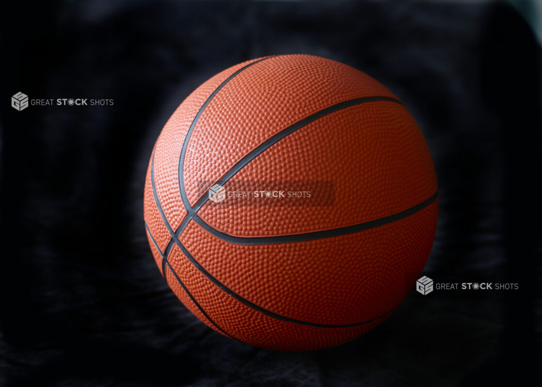 Orange and Black Basketball Ball Isolated Against a Black Background