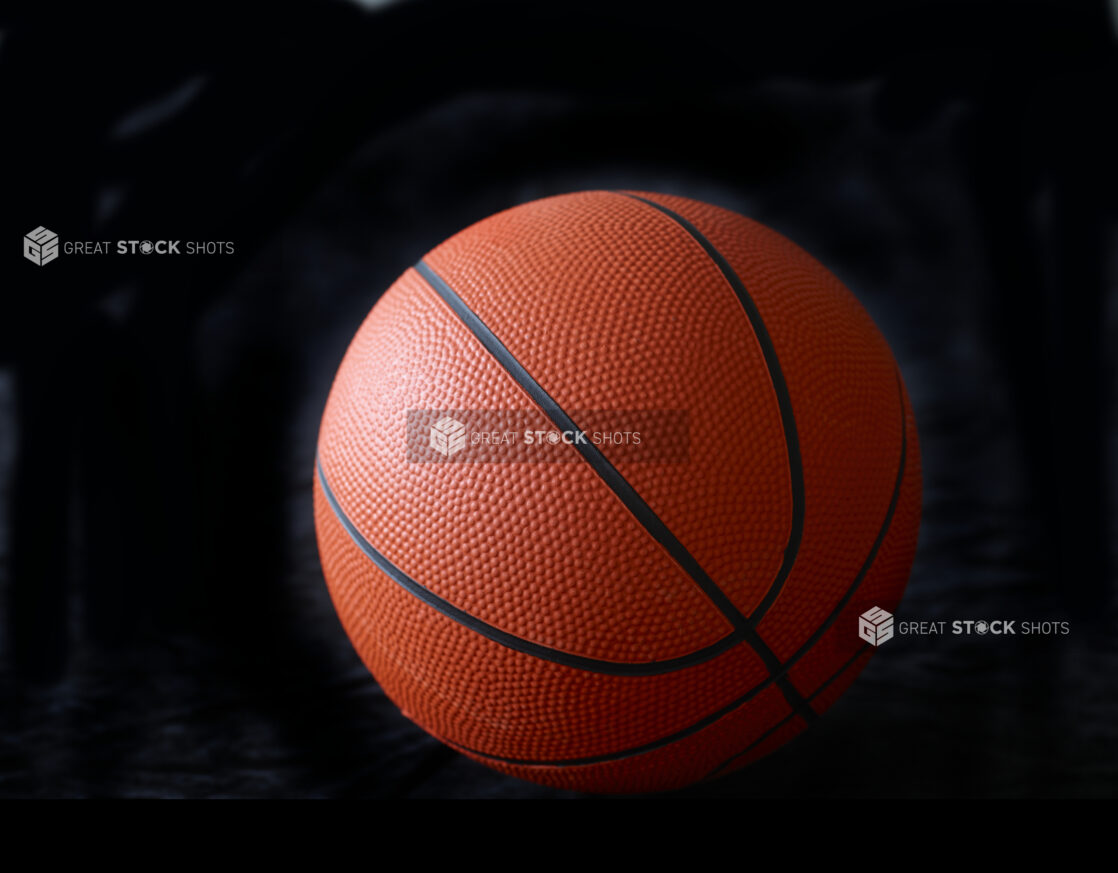 Orange and Black Basketball Ball Isolated Against a Black Background - Variation