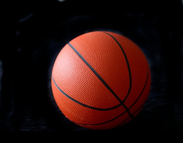 Orange and Black Basketball Ball Isolated Against a Black Background - Variation