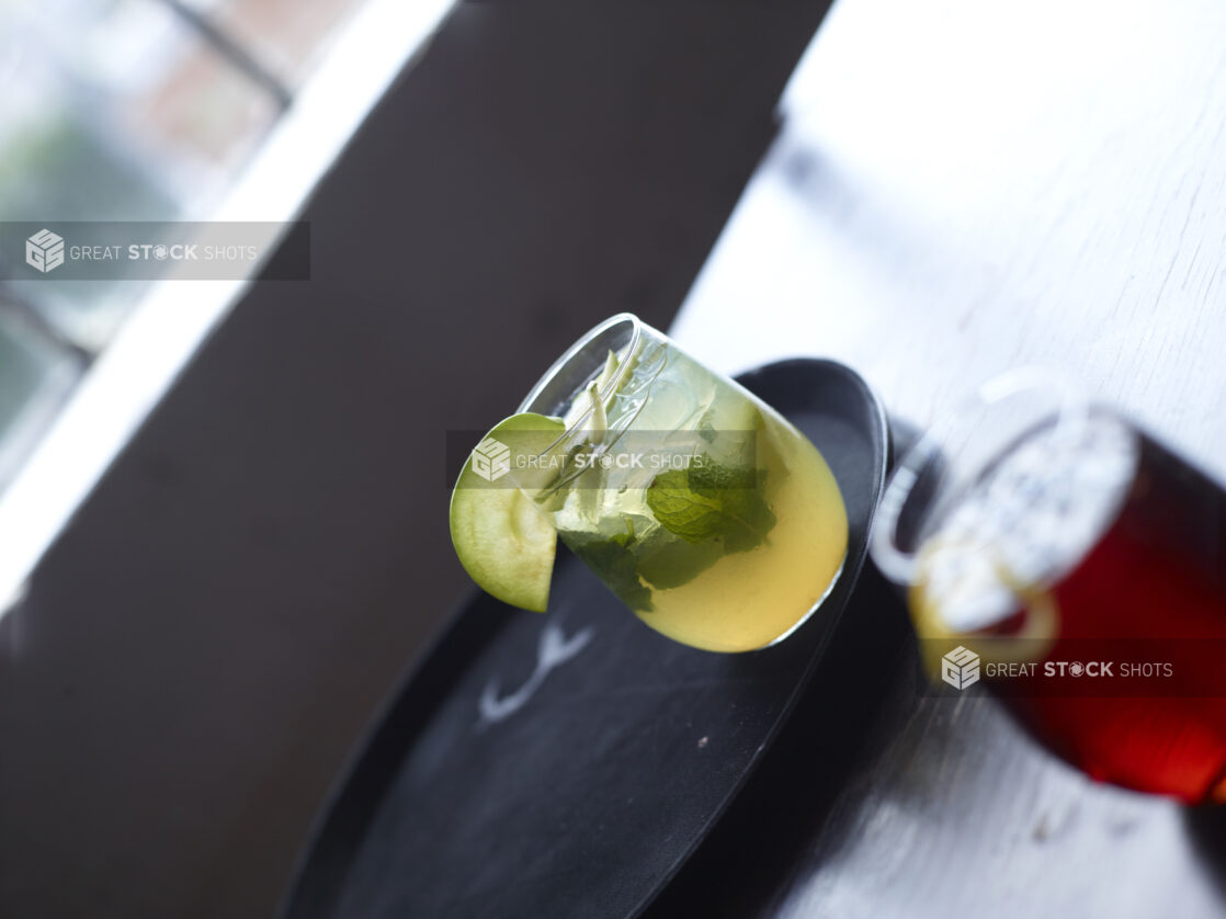 Mojito Cocktail Close Up with other Cocktails on Restaurant Table Setting - variation