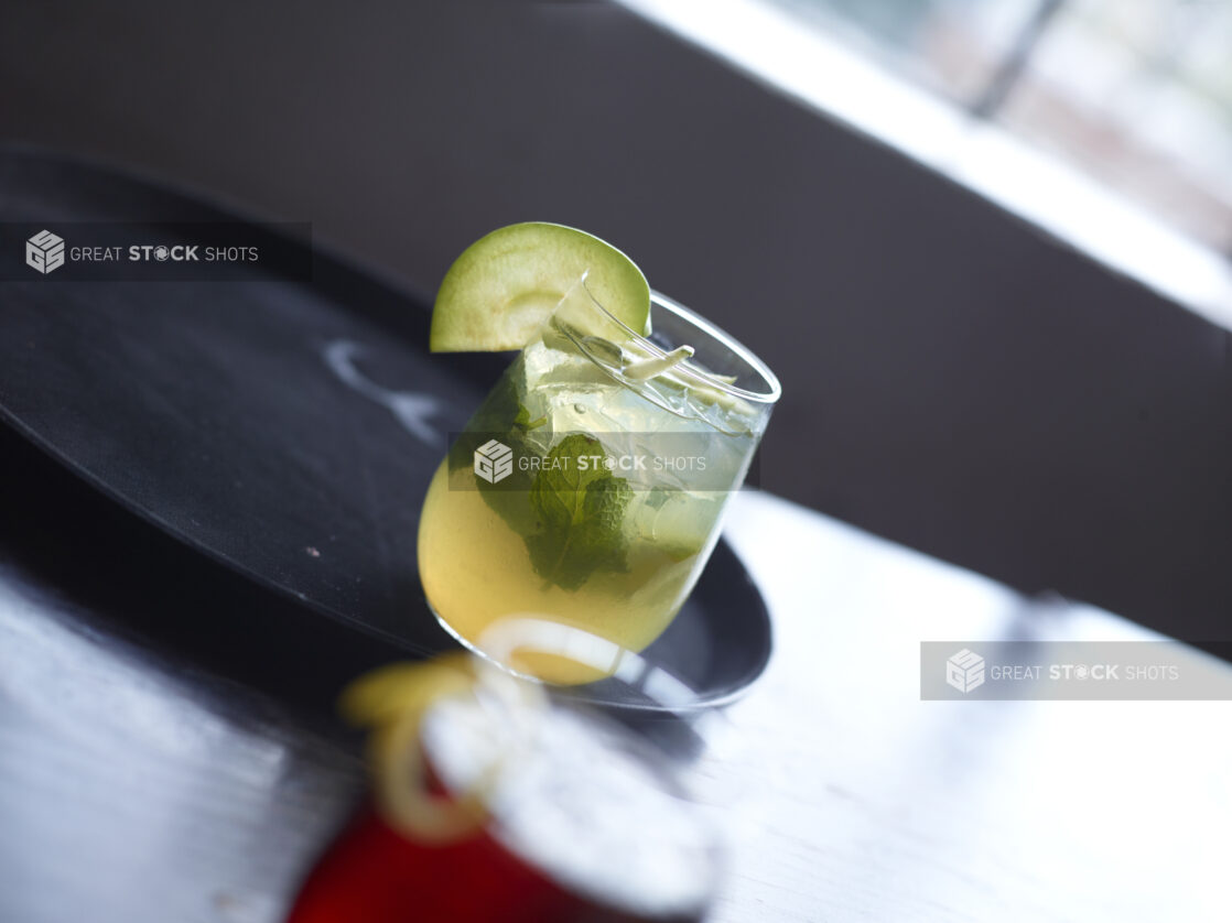 Mojito Cocktail Close Up with other Cocktails on Restaurant Table Setting - variation 2