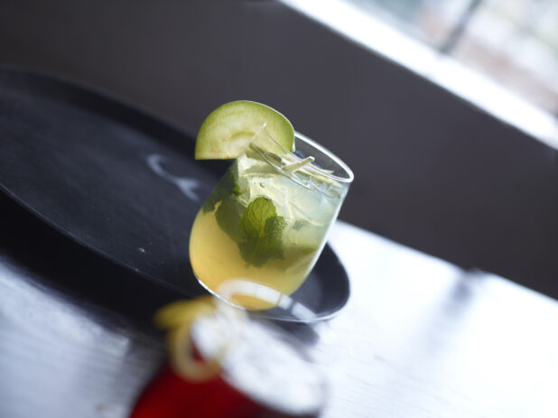 Mojito Cocktail Close Up with other Cocktails on Restaurant Table Setting - variation 2