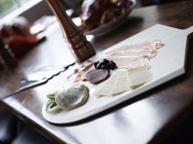 Charcuterie Board on Table in Restaurant Setting with Natural Light