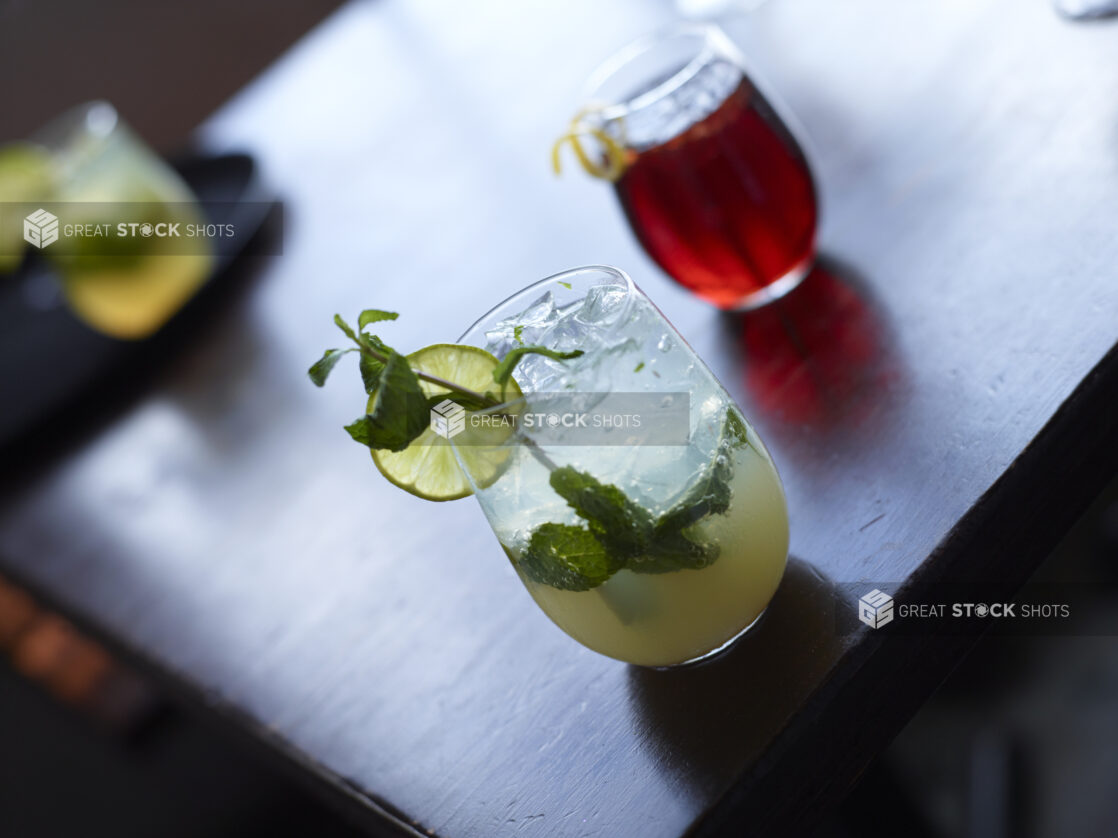 Mojito Cocktail Close Up with other Cocktails on Restaurant Table Setting