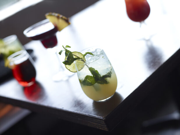 Mojito and Other Assorted Cocktails on Restaurant Table Setting