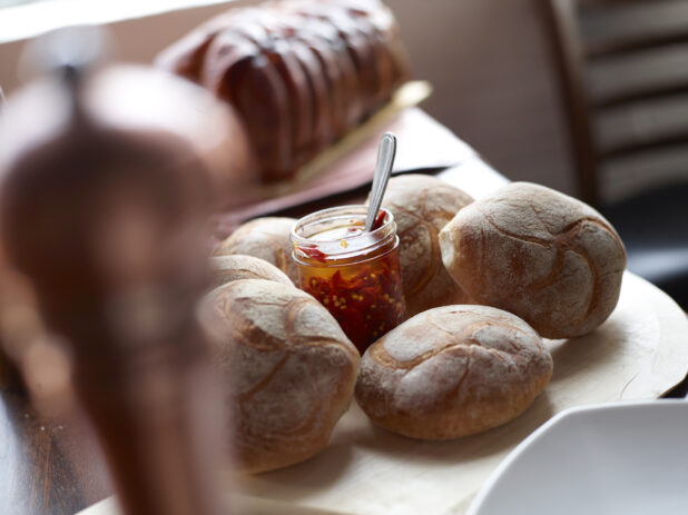 Fresh Baked Bread with Jar of Chili Oil and Porchetta Roast