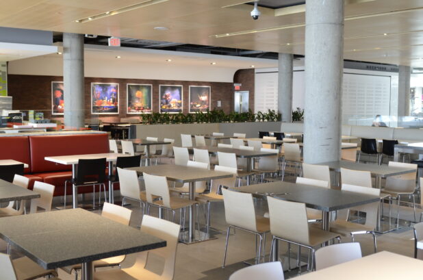 Empty food court with white tables, neutral palette