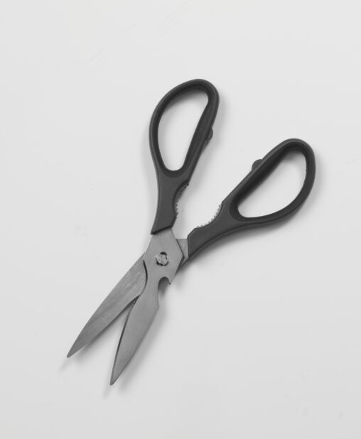 Pair of black-handled kitchen utility scissors on white background