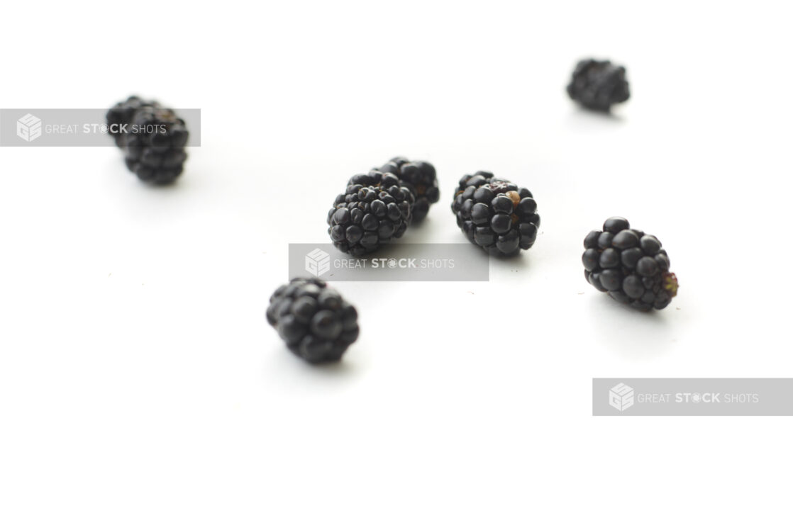 Fresh Blackberries Scattered on a White Surface