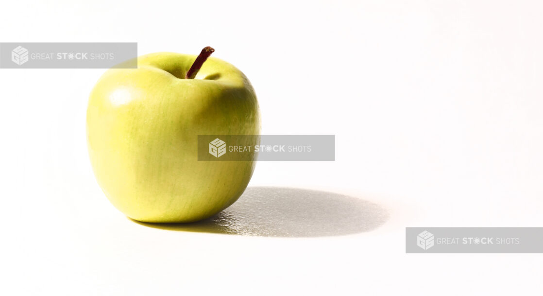 A Granny Smith apple on a white background