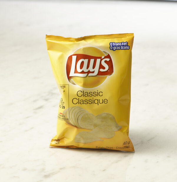 Individual bag of Lay's classic chips on marble background