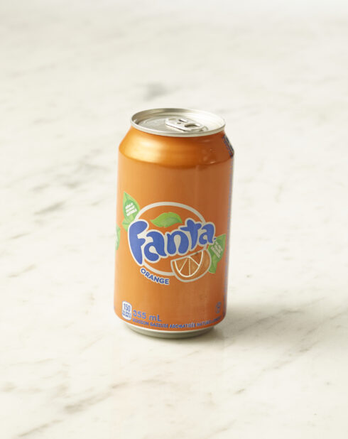 A can of orange Fanta on a marble background