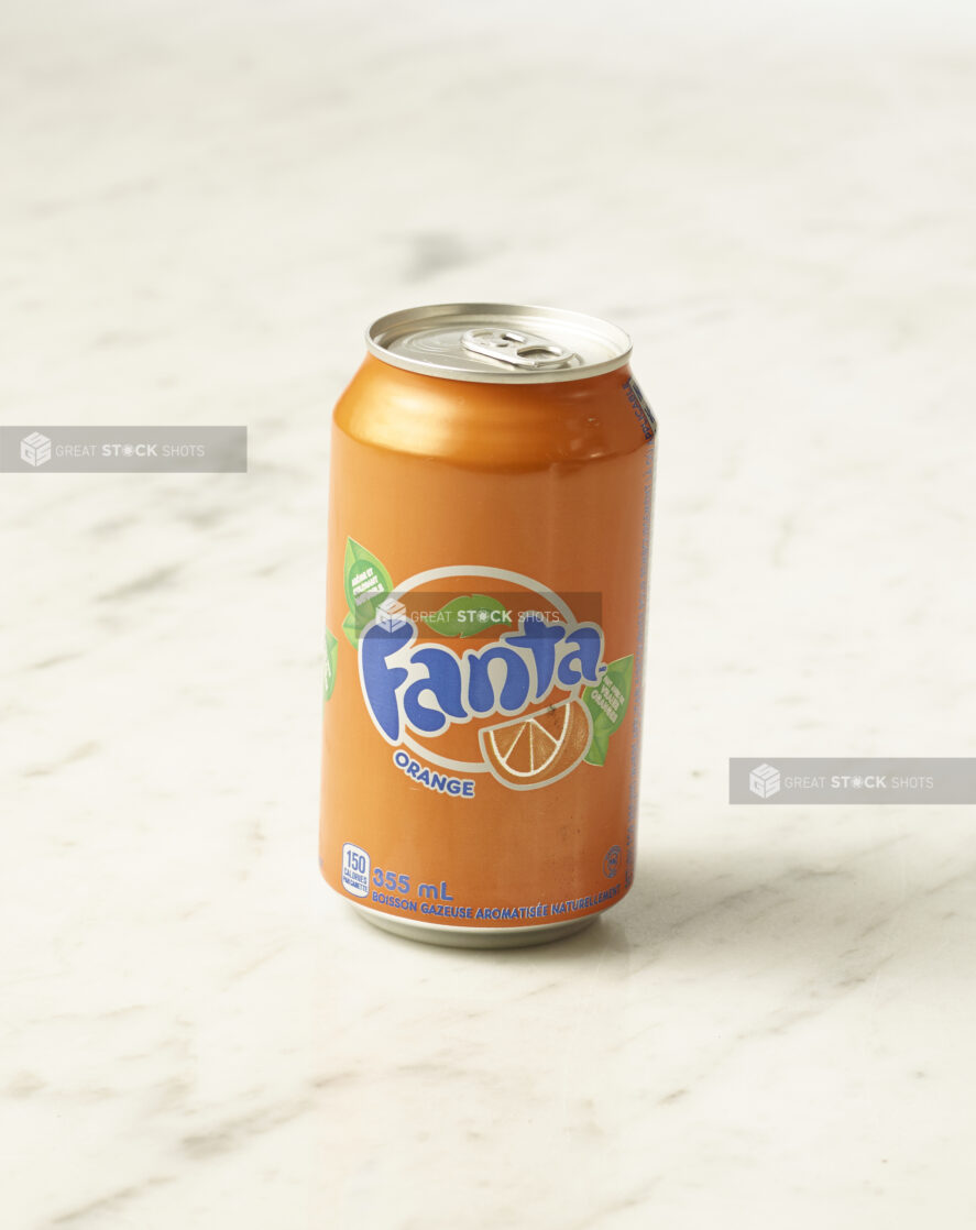 A can of orange Fanta on a marble background