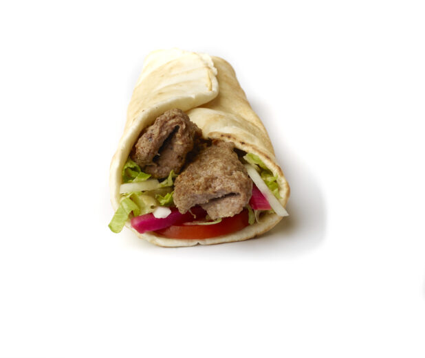 Beef Kebab Pita Wrap with Fresh Vegetable Toppings, Shot on White for Isolation