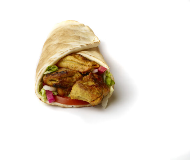 Chicken Kebab Pita Wrap with Fresh Vegetable Toppings, Shot on White for Isolation