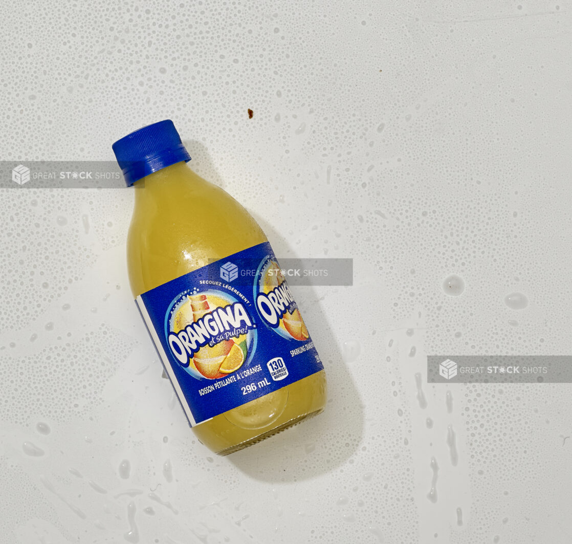 Overhead View of Orangina Sparkling Orange Beverage in a Glass Bottle, on a White Background for Isolation