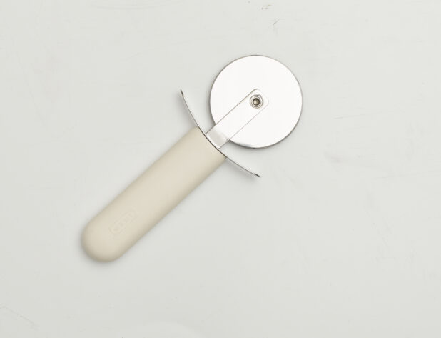 Overhead View of a Pizza Cutter with a Straight White Handle, on a White Background for Isolation