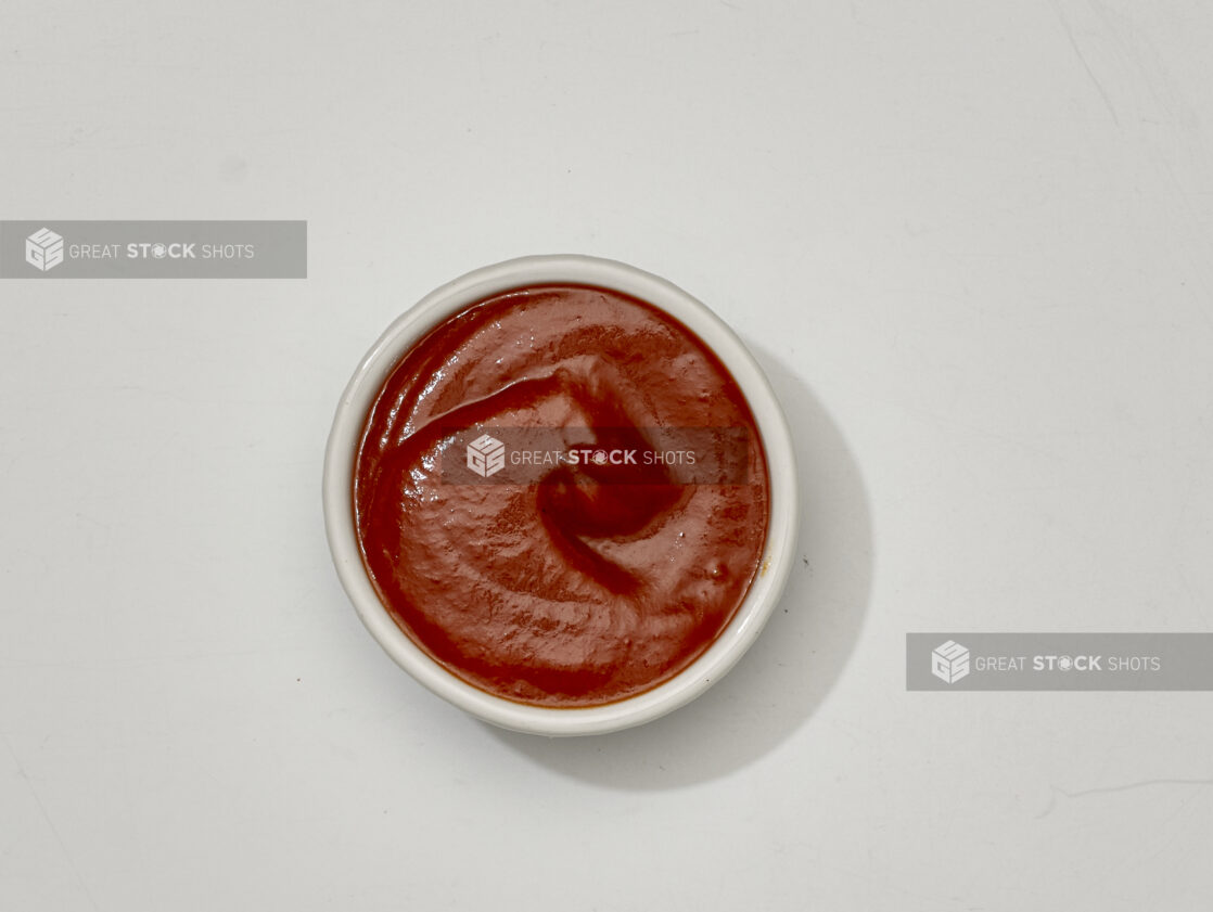 Overhead View of Marinara Sauce in a White Ceramic Ramekin, on a White Background for Isolation