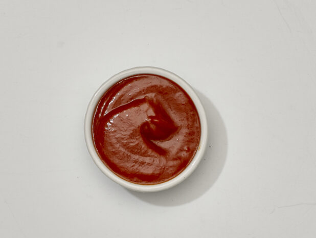Overhead View of Marinara Sauce in a White Ceramic Ramekin, on a White Background for Isolation