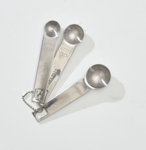Overhead View of a set of Metal Measuring Spoons with a Ball Link Chain, on a White Background for Isolation