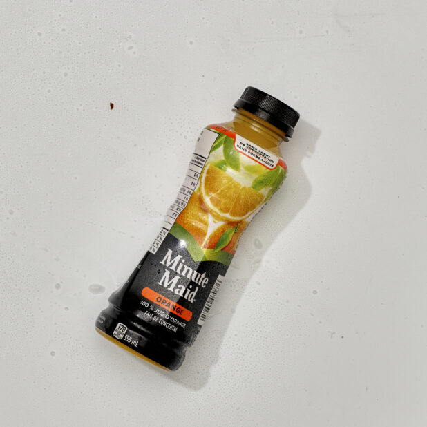 Overhead View of Minute Maid Brand Orange Juice in a Plastic Bottle, on a White Background for Isolation