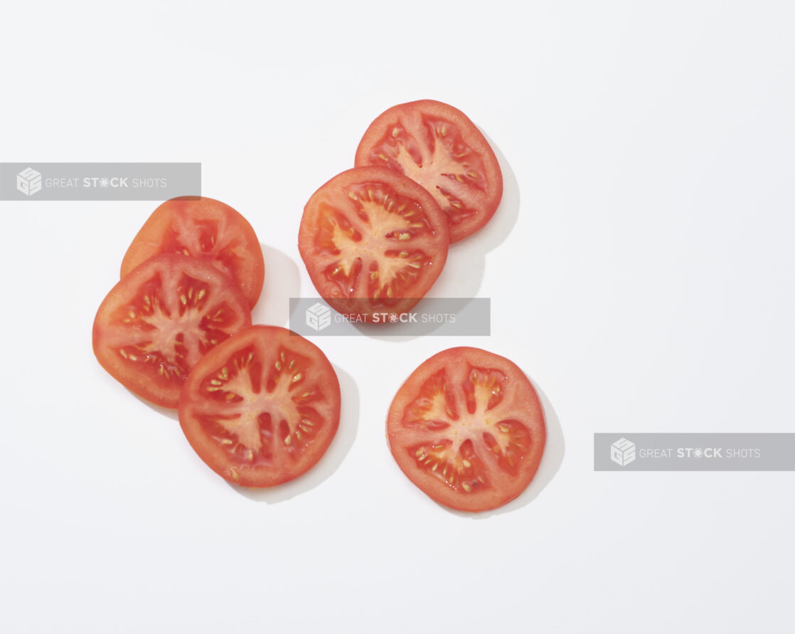 Slices of tomato on a white background