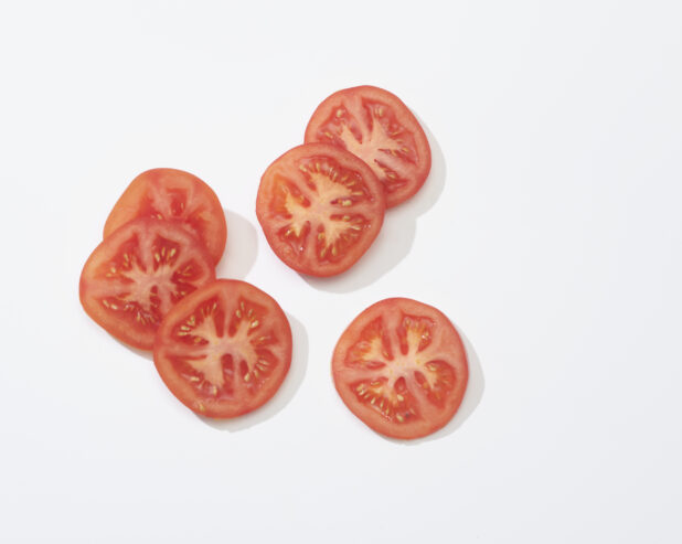 Slices of tomato on a white background