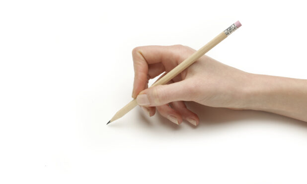 Close Up of a Person's Hand Holding a Sharpened School Pencil shot on White for Isolation