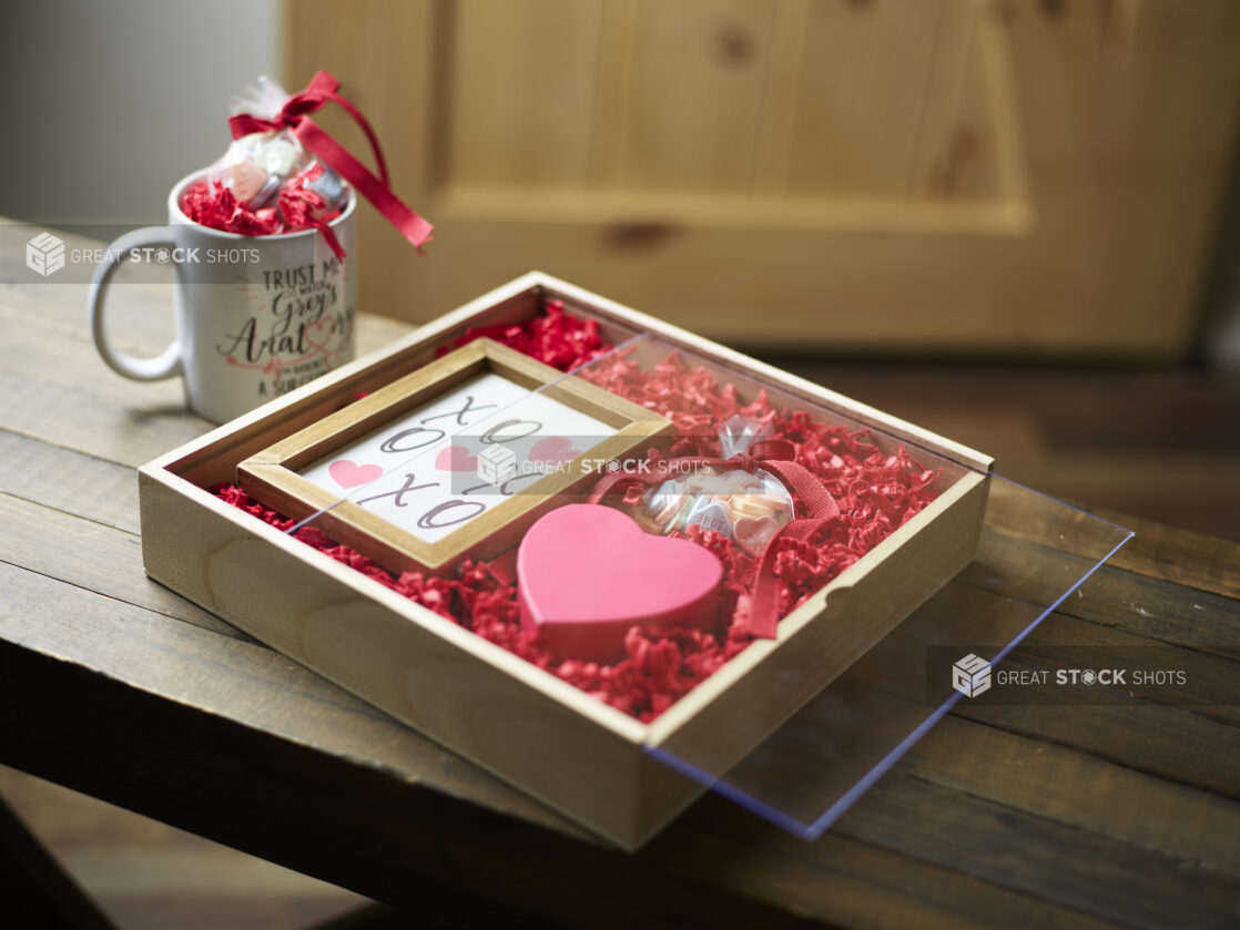 A wooden gift box for Valentine's Day with the company mug and picture frame