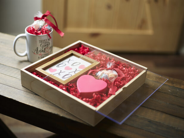 A wooden gift box for Valentine's Day with the company mug and picture frame
