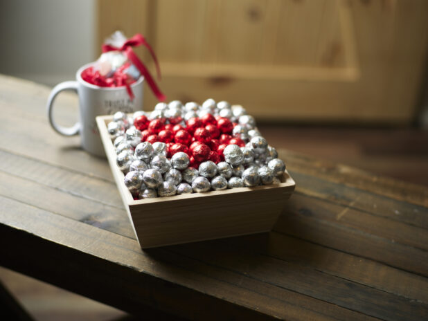 Valentine's Day gift box with red and silver chocolate foil balls and accompanying mug